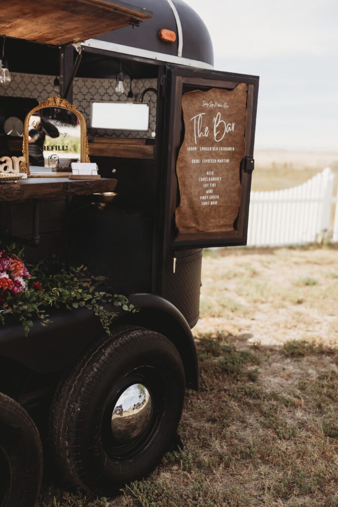 Mobile horse trailer bar Stetson serving handcrafted cocktails at an outdoor Colorado event as part of our Denver mobile bar service